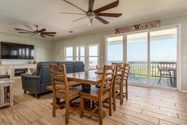 2802 Bienville Blvd, Dauphin Island, AL 36528 - dining room featuring crown molding, a ceiling fan, and light wood-style flooring