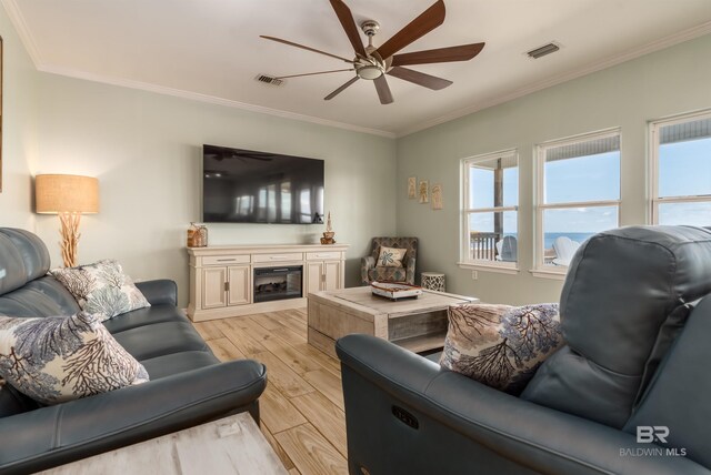 2802 Bienville Blvd, Dauphin Island, AL 36528 - living area featuring ceiling fan, visible vents, crown molding, light wood-type flooring, and a wealth of natural light