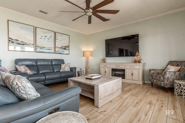 2802 Bienville Blvd, Dauphin Island, AL 36528 - living area featuring crown molding, a ceiling fan, light wood finished floors, and visible vents