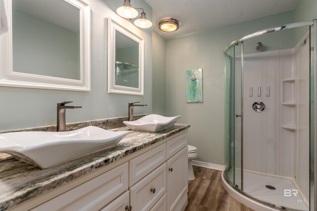2802 Bienville Blvd, Dauphin Island, AL 36528 - bathroom featuring wood finished floors, a sink, and a stall shower