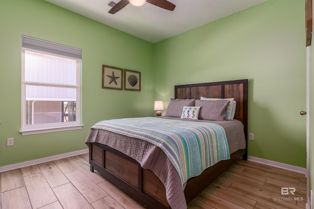 2802 Bienville Blvd, Dauphin Island, AL 36528 - bedroom with baseboards, a ceiling fan, and wood finished floors
