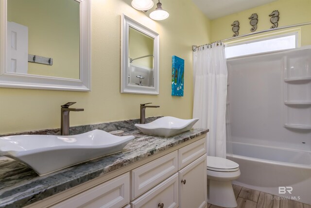 2802 Bienville Blvd, Dauphin Island, AL 36528 - full bath with double vanity, toilet, a sink, and shower / tub combo