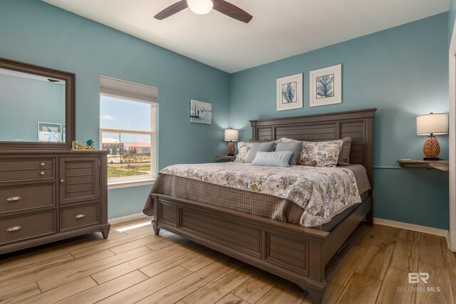 2802 Bienville Blvd, Dauphin Island, AL 36528 - bedroom with light wood-style floors, baseboards, and ceiling fan