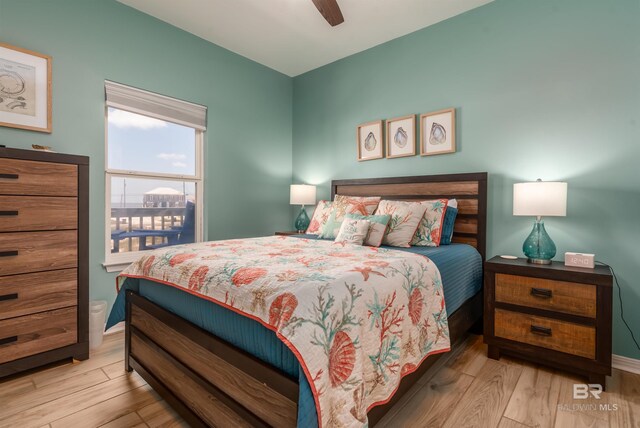 2802 Bienville Blvd, Dauphin Island, AL 36528 - bedroom featuring baseboards, a ceiling fan, and wood finished floors