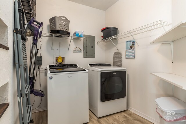 2802 Bienville Blvd, Dauphin Island, AL 36528 - laundry area with laundry area, electric panel, independent washer and dryer, baseboards, and light wood-style flooring