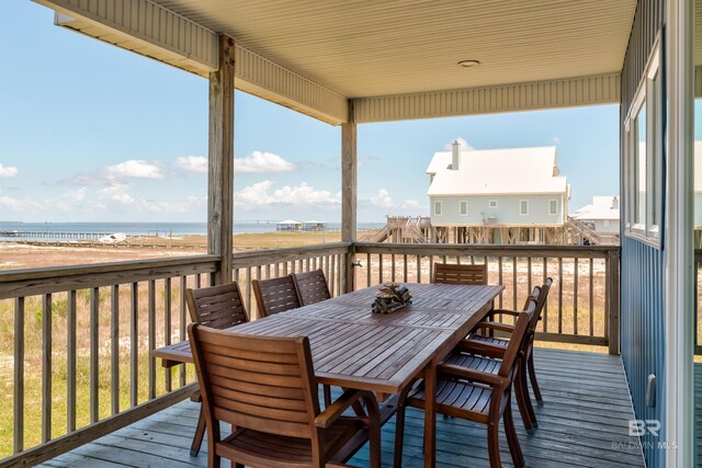 2802 Bienville Blvd, Dauphin Island, AL 36528 - wooden terrace with outdoor dining area and a water view