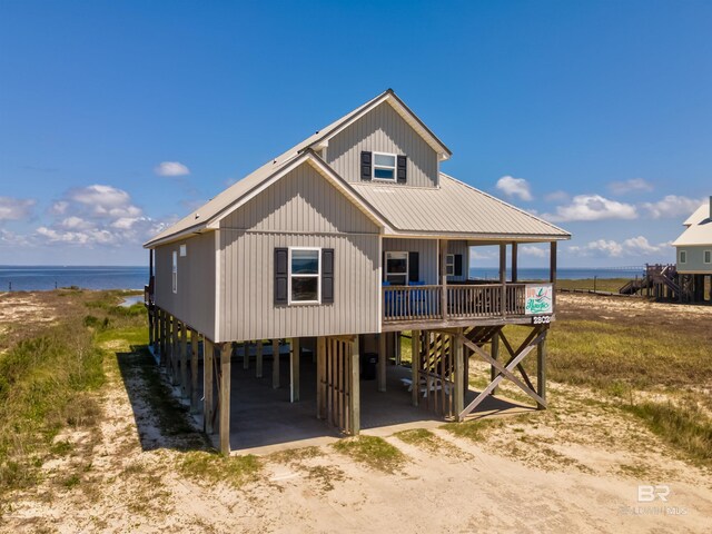 2802 Bienville Blvd, Dauphin Island, AL 36528 - rear view of property featuring a water view, driveway, and a carport