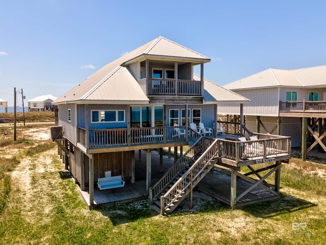 2802 Bienville Blvd, Dauphin Island, AL 36528 - rear view of house featuring a deck, metal roof, and a balcony