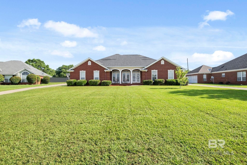 9554 Tunbridge Ct, Mobile, AL 36695 - traditional home featuring french doors, a front yard, and brick siding