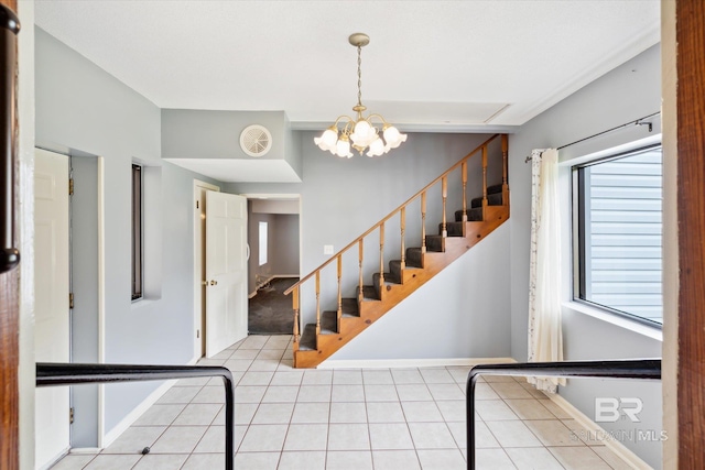 stairs with a notable chandelier and tile patterned floors