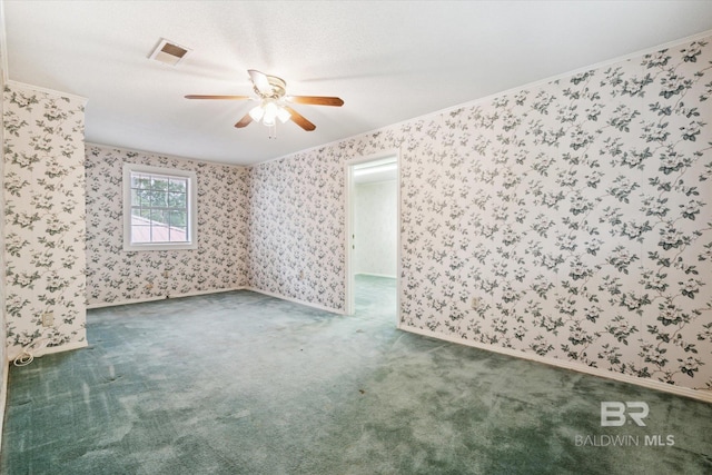 spare room with dark carpet, a textured ceiling, and ceiling fan