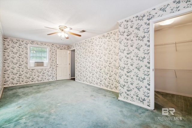 carpeted spare room featuring crown molding, cooling unit, and ceiling fan