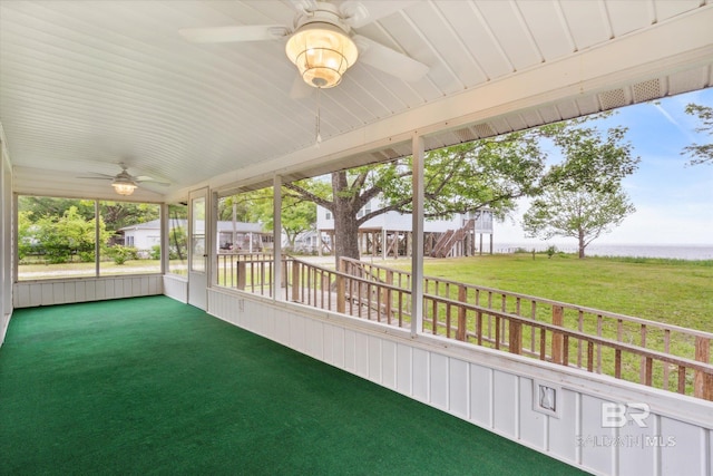 unfurnished sunroom featuring ceiling fan and vaulted ceiling