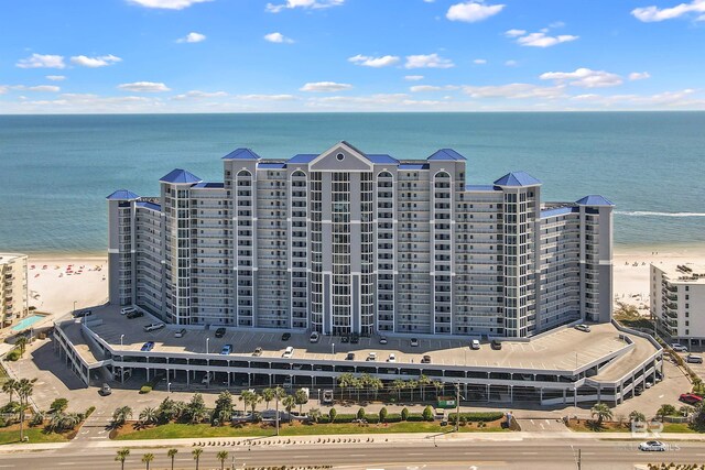 drone / aerial view with a water view and a view of the beach