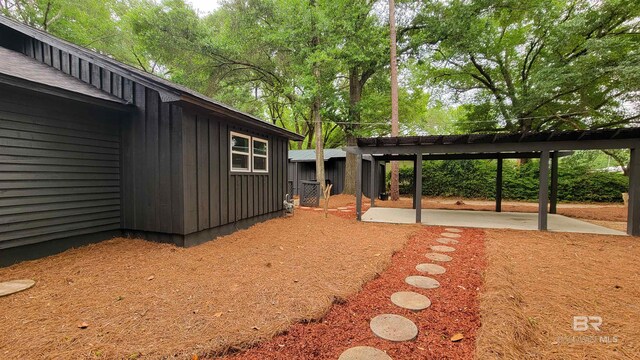 7770 Simmons Dr, Foley, AL 36535 - view of yard featuring a patio and view of wooded area