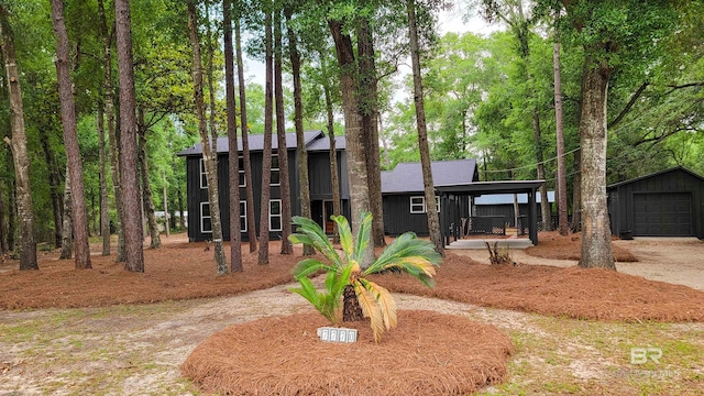 7770 Simmons Dr, Foley, AL 36535 - view of front facade with an outbuilding, a detached garage, driveway, and board and batten siding