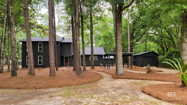 7770 Simmons Dr, Foley, AL 36535 - view of front of home featuring board and batten siding, an outbuilding, and a garage