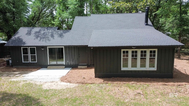 7770 Simmons Dr, Foley, AL 36535 - view of front of home with a shingled roof, central AC, board and batten siding, and view of scattered trees