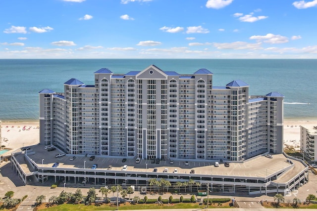 drone / aerial view with a beach view and a water view