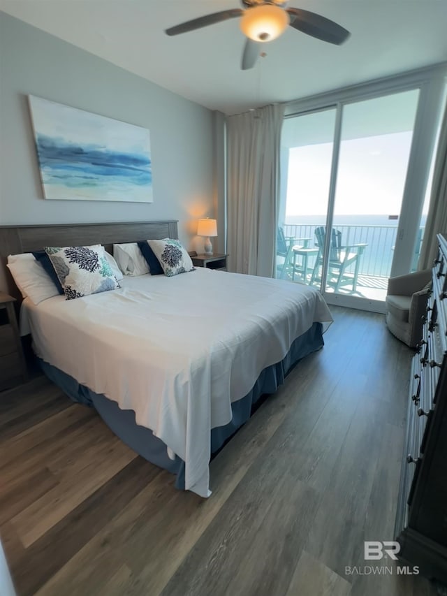 bedroom featuring a ceiling fan, access to outside, floor to ceiling windows, and wood finished floors