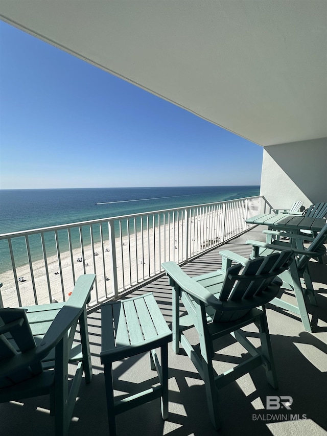 balcony featuring a water view and a view of the beach