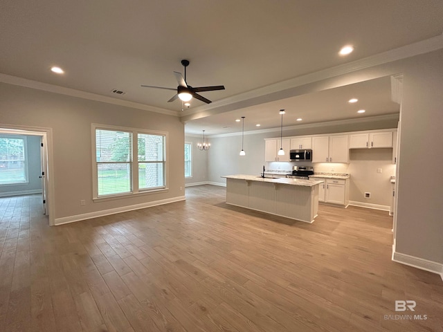 kitchen featuring white cabinetry, light stone counters, light hardwood / wood-style flooring, an island with sink, and stainless steel appliances