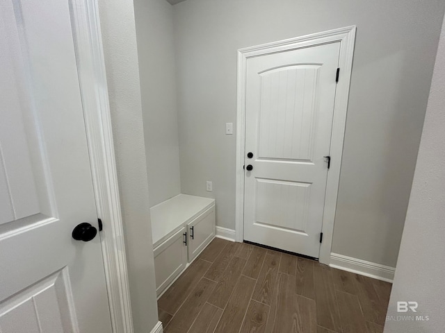 mudroom with baseboards and wood tiled floor