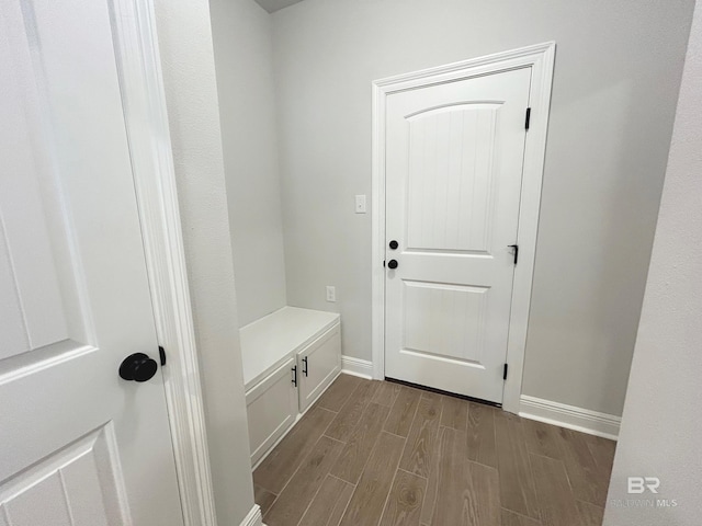 mudroom with baseboards and wood finish floors
