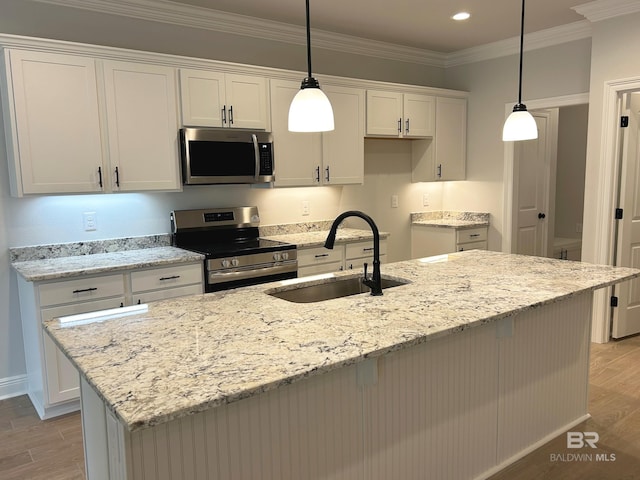 kitchen with stainless steel appliances, hanging light fixtures, and white cabinets