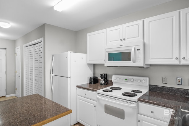 kitchen featuring white appliances and white cabinets