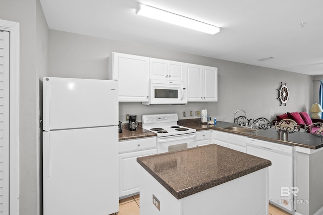 kitchen with a center island, white appliances, white cabinetry, sink, and light tile patterned flooring