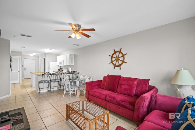 tiled living room with ceiling fan