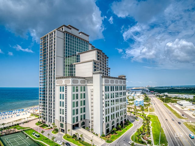 view of building exterior with a view of the beach and a water view