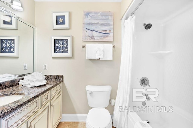 bathroom featuring vanity, baseboards, shower / bath combo, tile patterned flooring, and toilet