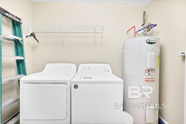 washroom featuring independent washer and dryer, water heater, and laundry area