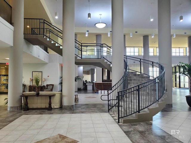 stairway featuring a high ceiling and tile patterned flooring