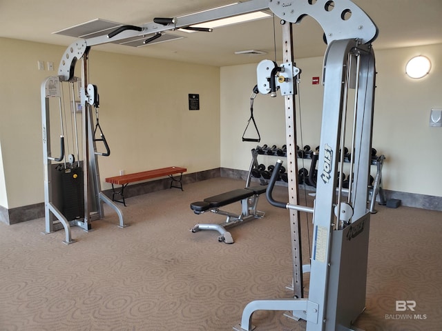 exercise room with baseboards