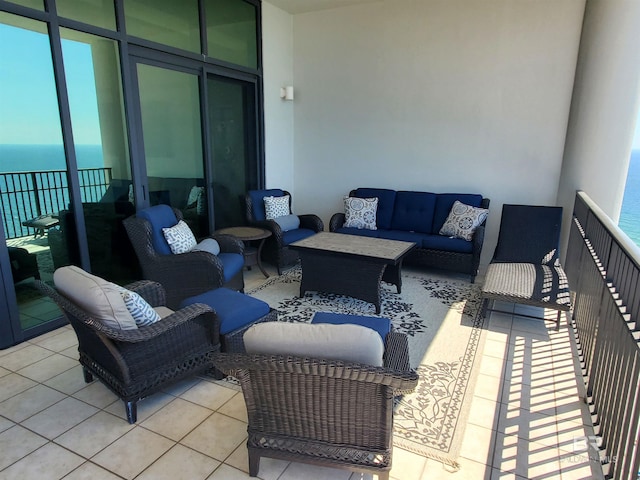 view of patio / terrace with an outdoor hangout area, a balcony, and a water view