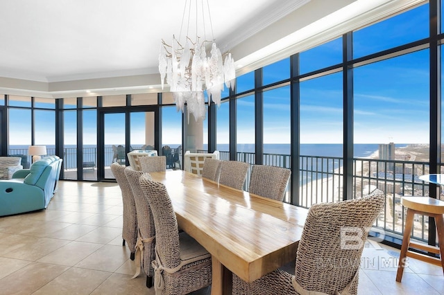 dining room with an inviting chandelier, ornamental molding, and floor to ceiling windows