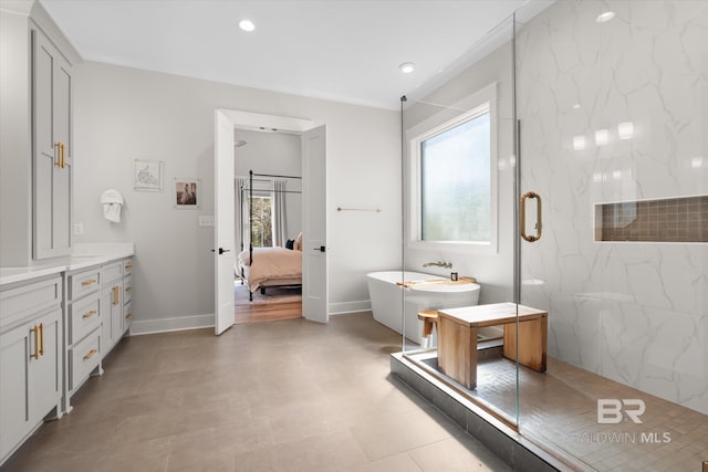 ensuite bathroom with a soaking tub, a healthy amount of sunlight, a marble finish shower, and connected bathroom