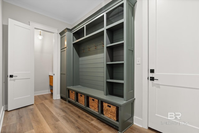 mudroom with baseboards, light wood-style floors, and ornamental molding