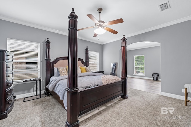 carpeted bedroom with crown molding and ceiling fan