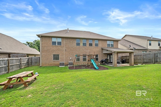 back of property with a patio, a playground, a lawn, and central air condition unit