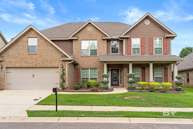 craftsman-style house with a garage, a front yard, and covered porch