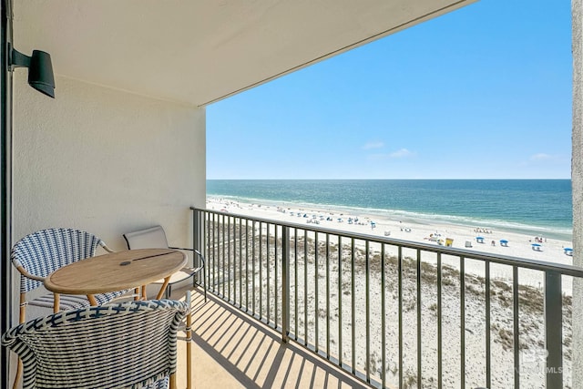 balcony featuring a water view and a beach view