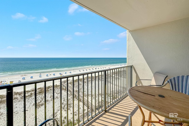 balcony with a water view and a beach view