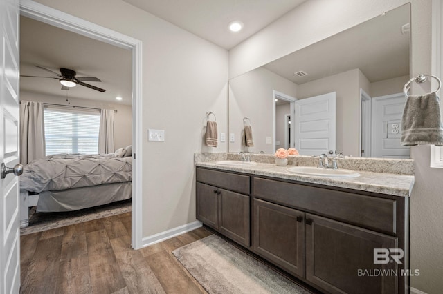 bathroom with hardwood / wood-style flooring, vanity, and ceiling fan