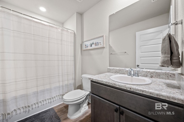 bathroom featuring hardwood / wood-style flooring, vanity, and toilet