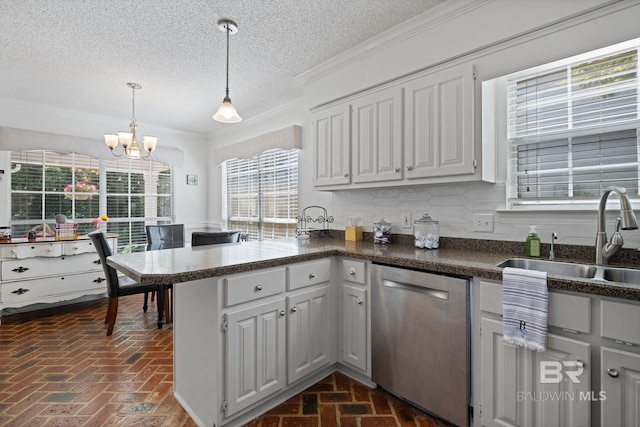 6417 Magnolia Place Ct, Mobile, AL 36695 - kitchen featuring dishwasher, brick floors, a sink, a peninsula, and a chandelier