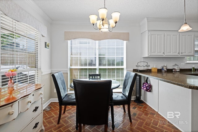 6417 Magnolia Place Ct, Mobile, AL 36695 - dining room with a chandelier, plenty of natural light, brick flooring, ornamental molding, and a textured ceiling